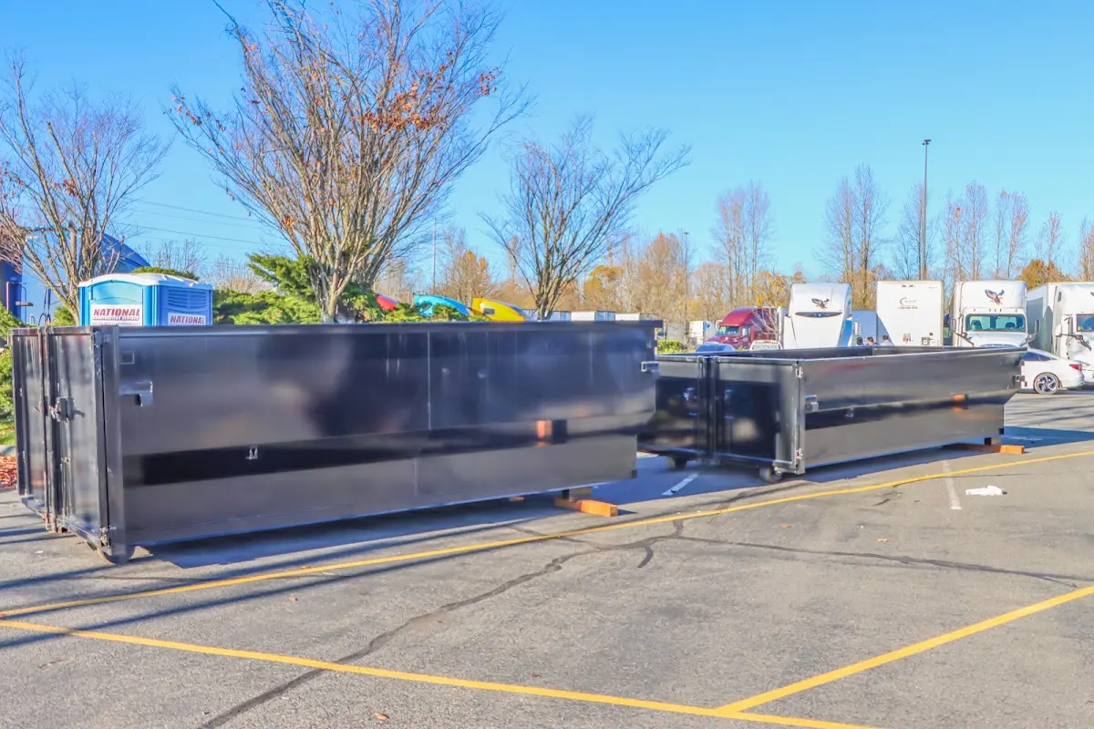 Professional dumpster rental service with roll-off container on residential driveway in Sioux Falls